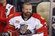 Florida Panthers goalie Tim Thomas (34) sits on the bench during an NHL hockey game between the Pittsburgh Penguins and the Florida Panthers in Pittsburgh, Monday, Jan. 20, 2014. The Panthers won 5-1. (AP Photo/Gene J. Puskar)
