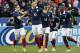 Karim Benzema of France, center, celebrates his goal with teammates during the international friendly match between France and Netherlands at the Stade de France stadium, outside Paris, Wednesday, March 5, 2014. (AP Photo/Christophe Ena)