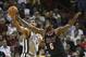 Miami Heat's LeBron James (6) fouls San Antonio Spurs' Tim Duncan (21) as he tries to steal the ball during the second half of an NBA basketball game in Miami, Sunday, Jan. 26, 2014. The Heat won 113-101. (AP Photo/J Pat Carter)