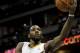 Denver Nuggets' Kenneth Faried tries to make a basket up and over Minnesota Timberwolves' Kevin Martin (23) but misses the shot during the first quarter of an NBA basketball game Monday, March 3, 2014, in Denver. (AP Photo/Barry Gutierrez)