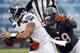 Seattle Seahawks quarterback Russell Wilson (3) scrambles away from Chicago Bears defensive tackle Henry Melton (69) in the first half of an NFL football game in Chicago, Sunday, Dec. 2, 2012. Wilson was able to get a pass off on the play. (AP Photo/Charles Rex Arbogast)