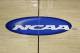 The NCAA logo is shown at half court during practice for second-round games of the NCAA college basketball tournament at The Palace in Auburn Hills, Mich., Wednesday, March 20, 2013. (AP Photo/Paul Sancya)