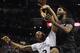 Miami Heat forward LeBron James, right, is fouled by San Antonio Spurs forward Kawhi Leonard during the second half of an NBA basketball game on Thursday, March 6, 2014, in San Antonio. San Antonio won 111-87. (AP Photo/Darren Abate)