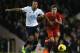 Tottenham's Mousa Dembele, left holds off the challenge of Liverpool's Philippe Coutinho during their English Premier League soccer match between Tottenham Hotspur and Liverpool at the White Hart Lane stadium in London Sunday, Dec. 15, 2013. (AP Photo/Alastair Grant)