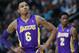 Los Angeles Lakers guard Kent Bazemore, front, looks on against the Denver Nuggets as guard MarShon Brooks, back, checks in to play in the first quarter of an NBA basketball game in Denver on Friday, March 7, 2014. (AP Photo/David Zalubowski)