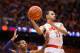SYRACUSE, NY - FEBRUARY 9: Tyler Ennis #11 of the Syracuse Orange makes a jumping pass while being defended by Jaron Blossomgame #5 of the Clemson Tigers during the second half on February 9, 2014 at The Carrier Dome in Syracuse, New York. Syracuse defeats Clemson 57-44. (Photo by Brett Carlsen/Getty Images)