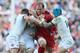 Wales's Alun Wyn Jones, center, is tackled by England's Jack Nowell, right, and Danny Care during the Six Nations Rugby Union match between England and Wales at Twickenham stadium in London Sunday, March, 9, 2014. (AP Photo/Alastair Grant)
