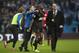 Wigan's Emmerson Boyce, centre, is congratulated by teammate Callum McManaman, centre left, after their 2-1 win against Manchester City following their English FA Cup quarterfinal soccer match at the Etihad Stadium, Manchester, England, Sunday, March 9, 2014. (AP Photo/Jon Super)