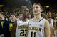 Michigan guard Caris LeVert (23) and guard Nik Stauskas (11) stand with teammates on the court waiting for an awards ceremony, after an NCAA college basketball game against Indiana at Crisler Center in Ann Arbor, Mich., Saturday, March 8, 2014. Michigan won 84-80, and celebrated their outright Big Ten regular season championship. (AP Photo/Tony Ding)