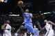 Los Angeles Clippers guard Jamal Crawford (11) goes up for a shot between Oklahoma City Thunder defenders Reggie Jackson (15) and Kevin Durant (35) in the second quarter of an NBA basketball game, Sunday, Feb. 23, 2014, in Oklahoma City. (AP Photo/Sue Ogrocki)