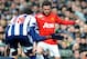 Manchester United's Juan Mata is held back by West Brom's Youssuf Mulumbu during the English Premier League soccer match between West Bromwich Albion and Manchester United at The Hawthorns Stadium in West Bromwich, England, Saturday, March 8, 2014. (AP Photo/Rui Vieira)