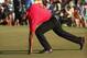 Just picking his ball up from the hole is difficult for Tiger Woods right now.
