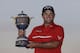 Patrick Reed holds The Gene Sarazen Cup after winning the Cadillac Championship golf tournament Sunday, March 9, 2014, in Doral, Fla. Reed won with a score 4-under-par 284 (AP Photo/Wilfredo Lee)