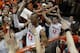 Virginia forward Akil Mitchell, front, and Joe Harris (12) are swarmed by fans as they celebrate their win over Syracuse after an NCAA College basketball game in Charlottesville, Va., Saturday, March 1, 2014. Virginia won the game 75-56. (AP Photo/Steve Helber)