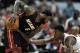 Miami Heat's LeBron James (6) looks to drive around Chicago Bulls' Jimmy Butler during overtime of an NBA basketball game in Chicago, Sunday, March 9, 2014. The Bulls won 95-88. (AP Photo/ Paul Beaty)