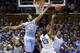 Duke's Matt Jones (13) shoots as North Carolina's James Michael McAdoo (43) and Desmond Hubert (14) defend during the first half of an NCAA college basketball game in Durham, N.C., Saturday, March 8, 2014. (AP Photo/Gerry Broome)