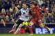 Liverpool's Joe Allen, right, and Norwich City's Wesley Hoolahan battle for the ball during their English Premier League soccer match at Anfield in Liverpool, England, Wednesday Dec. 4, 2013. (AP Photo/Clint Hughes)