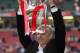 CARDIFF, UNITED KINGDOM - MAY 21: Arsenal Manager, Arsene Wenger holds aloft the trophy after winning the FA Cup Final between Arsenal and Manchester United 5-4 on penalty's at The Millennium Stadium on May 21, 2005 in Cardiff, Wales. (Photo by Ross Kinnaird/Getty Images)