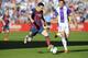 Barcelona's Lionel Messi from Argentina, left, and Valladolid's defender Jesus Rueda challenge for the ball during a Spanish La Liga soccer match at the Jose Zorrilla stadium in Valladolid, Spain, Saturday March 8, 2014. (AP Photo/Israel L. Murillo)