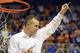Florida coach Billy Donovan holds up a piece of the net after the Gators became the first team in Southeastern Conference history to go 18-0 in league pla, Saturday, March 8, 2014 in Gainesville, Fla. Florida defeated Kentucky 84-65 Saturday in an NCAA college basketball game. (AP Photo/Phil Sandlin)