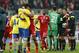 Arsenal's Per Mertesacker, front left, hugs Bayern's Dante after the Champions League round of 16 second leg soccer match between FC Bayern Munich and FC Arsenal in Munich, Germany, Wednesday, March 12, 2014. (AP Photo/Matthias Schrader)