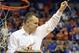 Florida coach Billy Donovan holds up a piece of the net after the Gators became the first team in Southeastern Conference history to go 18-0 in league pla, Saturday, March 8, 2014 in Gainesville, Fla. Florida defeated Kentucky 84-65 Saturday in an NCAA college basketball game. (AP Photo/Phil Sandlin)