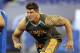 Michigan offensive lineman Taylor Lewan runs a drill at the NFL football scouting combine in Indianapolis, Saturday, Feb. 22, 2014. (AP Photo/Michael Conroy)