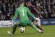 Barcelona's Daniel Alves scores his side's first goal next to Manchester City's goalkeeper Joe Hart during their Champions League first knock out round soccer match at the Etihad Stadium, Manchester, England, Tuesday Feb. 18, 2014. (AP Photo/Jon Super)