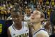 Michigan guard Caris LeVert, left, and guard Nik Stauskas, right, celebrate with their teammates after an NCAA college basketball game against Indiana at Crisler Center in Ann Arbor, Mich., Saturday, March 8, 2014. Michigan won 84-80, and celebrated their outright Big Ten regular season championship. (AP Photo/Tony Ding)