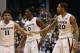 Xavier's Dee Davis, Semaj Christon, and Justin Martin, lef to right, congratulate each other near the end of the game with Creighton in the second half of their NCAA college basketball game at Xavier University in Cincinnati Saturday March 1, 2014. Xavier won 75-69. (AP Photo/Tom Uhlman)
