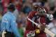 West Indies' Dwayne Bravo, right, and Darren Sammy embrace after beating England by 5 wickets with 7 balls remaining during their second T20 International cricket match at the Kensington Oval in Bridgetown, Barbados, Tuesday, March 11, 2014. (AP Photo/Ricardo Mazalan)