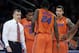 Florida head coach Billy Donovan, left, talks with his team during a timeout during the second half of an NCAA college basketball game against Memphis in New York, Tuesday, Dec. 17, 2013. Florida defeated Memphis 77-75. (AP Photo/Seth Wenig)