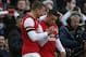 Arsenal's Alex Oxlade-Chamberlain, right, celebrates his goal against Liverpool with teammate Lukas Podolski during their English FA Cup fifth round soccer match at Emirates Stadium in London, Sunday, Feb. 16, 2014. (AP Photo/Sang Tan)