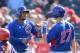 TEMPE, AZ - MARCH 07: Luis Valbuena #24 and teammate Josh Vitters #27 of the Chicago Cubs celebrate scoring a seventh inning run against the Anaheim Angels at Tempe Diablo Stadium on March 7, 2014 in Tempe, Arizona. (Photo by Norm Hall/Getty Images)