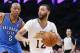 Los Angeles Lakers point guard Kendall Marshall dribbles around Oklahoma City Thunder small forward Caron Butler, center, and Oklahoma City Thunder shooting guard Jeremy Lamb during the second half of an NBA basketball game in Los Angeles, Sunday, March 9, 2014. The Lakers won 114-110. (AP Photo/Danny Moloshok)