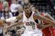 Atlanta Hawks forward Mike Scott, right, plays tight defense on Portland Trail Blazers forward LaMarcus Aldridge during the first half of an NBA basketball game in Portland, Ore., Wednesday, March 5, 2014. (AP Photo/Don Ryan)