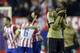 AC Milan's Mario Balotelli walks on the pitch as Atletico Madrid players celebrate in background, during a Champions League, round of 16, second leg, soccer match between Atletico Madrid and AC Milan at the Vicente Calderon stadium in Madrid, Tuesday March 11, 2014. (AP Photo/Paul White)