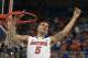 Florida guard Scottie Wilbekin (5) holds up a piece of the net after the Gators became the first team in Southeastern Conference history to go 18-0 in league pla, Saturday, March 8, 2014 in Gainesville, Fla. Florida defeated Kentucky 84-65 Saturday in an NCAA college basketball game. (AP Photo/Phil Sandlin)