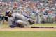 Los Angeles Dodgers' fielder Matt Kemp grimaces as he was out at home and hurt on the play against the Washington Nationals during the ninth inning of a baseball game, Sunday, July 21, 2013, in Washington. The Dodgers won 9-2. (AP Photo/Nick Wass)