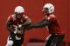 Nebraska quarterback Tommy Armstrong Jr., right, fakes a handoff to running back Imani Cross (32) on the first day of sping NCAA college football practice in Lincoln, Neb., Saturday, March 8, 2014. (AP Photo/Nati Harnik)