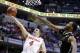 Ohio State guard Aaron Craft (4) goes up for a shot against Purdue forward Errick Peck in the second half of an NCAA college basketball game in the first round of the Big Ten Conference tournament Thursday, March 13, 2014, in Indianapolis. Ohio State won 63-61. (AP Photo/Michael Conroy)
