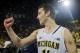Michigan guard Nik Stauskas (11) cheers after an NCAA college basketball game against Indiana in Ann Arbor, Mich., Saturday, March 8, 2014. Michigan won 84-80. (AP Photo/Tony Ding)