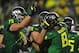 EUGENE, OR. - SEPTEMBER 28: Quarterback Marcus Mariota #8 of the Oregon Ducks celebrates with the teammates including offensive linesman Jake Fisher #75 and offensive linesman Tyler Johnstone #64 of the Oregon Ducks after scoring a touchdown during the second quarter of the game against the California Golden Bears at Autzen Stadium on September 28, 2013 in Eugene, Oregon. (Photo by Steve Dykes/Getty Images)