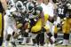 Iowa running back Damon Bullock, center, is tackled by Michigan State's Max Bullough, left, and Trae Waynes during the first half of an NCAA college football game, Saturday, Oct. 5, 2013, in Iowa City, Iowa. Michigan State won 26-14. (AP Photo/Charlie Neibergall)
