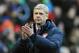 Arsenal manager Arsene Wenger applauds fans after the English Premier League soccer match between Stoke City and Arsenal at Britannia Stadium in Stoke On Trent, England, Saturday, March 1, 2014. (AP Photo/Rui Vieira)