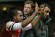 Arsenal's Theo Walcott gestures to the crowd to show the score of 2-0, as he is stretchered off in front of Tottenham fans during the English FA Cup third round soccer match between Arsenal and Tottenham Hotspur at the Emirates Stadium in London, Saturday, Jan. 4, 2014. Arsenal won the match 2-0. (AP Photo/Kirsty Wigglesworth)