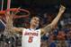 Florida guard Scottie Wilbekin (5) holds up a piece of the net after the Gators became the first team in Southeastern Conference history to go 18-0 in league pla, Saturday, March 8, 2014 in Gainesville, Fla. Florida defeated Kentucky 84-65 Saturday in an NCAA college basketball game. (AP Photo/Phil Sandlin)
