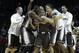 St. Bonaventure's Jordan Gathers, center, is mobbed by teammates after sinking the winning basket during the second half of an NCAA college basketball game against Saint Louis in the quarterfinal round of the Atlantic 10 Conference tournament at the Barclays Center in New York, Friday, March 14, 2014. St. Bonaventure beat Saint Louis 71-68. (AP Photo/Seth Wenig)