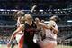 Toronto Raptors center Jonas Valanciunas (17) blocks out Chicago Bulls power forward Taj Gibson (22) and center Joakim Noah under the basket during the second half of an NBA basketball game Tuesday, Dec. 31, 2013, in Chicago. The Raptors won 85-79. (AP Photo/Charles Rex Arbogast)