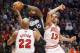 Sacramento Kings center DeMarcus Cousins (15) grabs a rebound over Chicago Bulls forward Taj Gibson (22) and center Joakim Noah during the first half of an NBA basketball game, Wednesday, Oct. 31, 2012, in Chicago. (AP Photo/Charles Rex Arbogast)